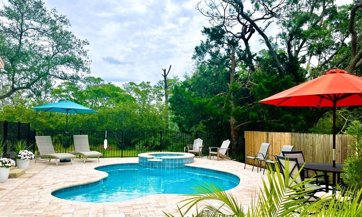 Butler Beach House | Paradise by the River - Relax in Style Near the Beach! Pool and Heated Spa