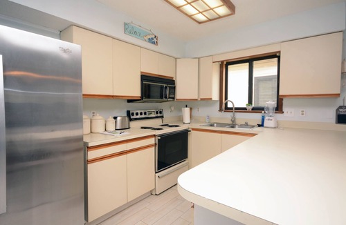 Caine Woods Condo | 2-bedroom condo with an outdoor pool located uptown on the bayside in a peaceful, family-friendly neighborhood!