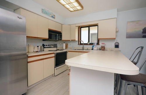Caine Woods Condo | 2-bedroom condo with an outdoor pool located uptown on the bayside in a peaceful, family-friendly neighborhood!