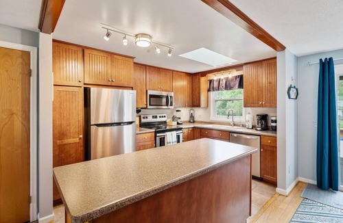 Romulus House | A dreamy Seneca Lake retreat with sweeping views, a relaxing hot tub under the stars, flexible bedroom setups, a fully stocked kitchen, cozy living spaces, and easy access to the lake, wineries, and waterfalls.
