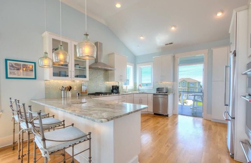 Caswell Beach House | Experience ocean views at 'West with the Night' in Oak Island, perfect for families.