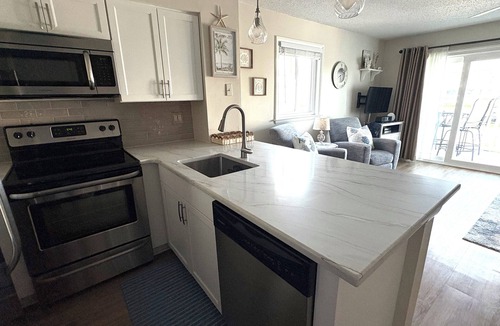North Ocean City Condo | Hidden Harbor - canal front 1st floor condo with balcony, shared pool, next to Northside Park.
