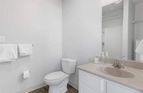 Central City Apartment | Modern loft with rooftop deck, fitness center, and private parking.