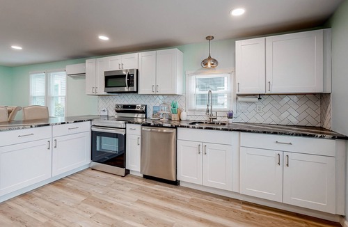 Montego Bay House | Updated dog-friendly home with gas grill, 2 pools, 2 tennis courts, fishing pier